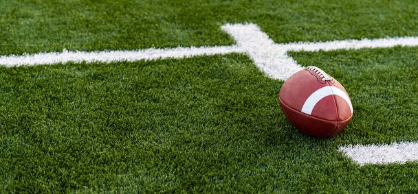 a brown leather American Football on a field - Photo, Image