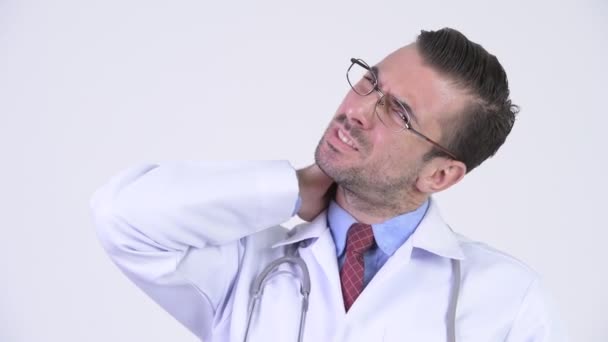 Young stressed Hispanic man doctor having neck pain - Filmagem, Vídeo