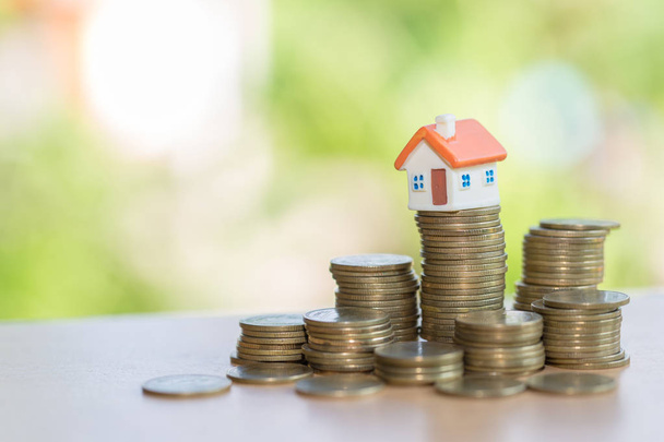 Mini house on stack of coins,Money and house, Real estate investment, Save money with stack coin, Mortgage concept.  - Photo, Image