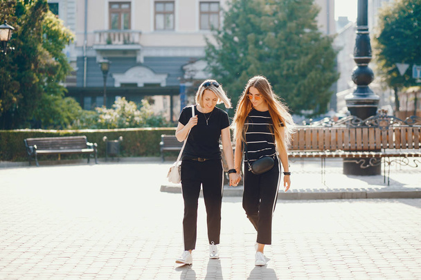 Mother with daughter in a city - Фото, зображення
