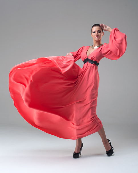girl in a long red dress dancing - Fotoğraf, Görsel