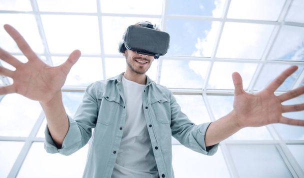 Beautiful man is wearing glasses of virtual reality - Фото, изображение