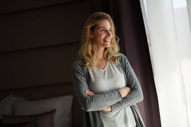Portrait of beautiful blonde woman standing in room - Photo, Image