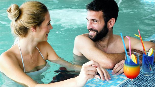 couple relaxing in swimming pool - 写真・画像