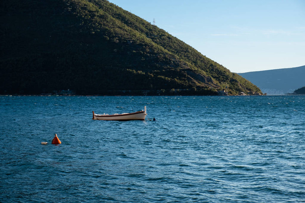 Beautiful Mediterranean landscape, mountains, sea and boat on the water. Montenegro, Adriatic Sea, Bay of Kotor - Фото, зображення