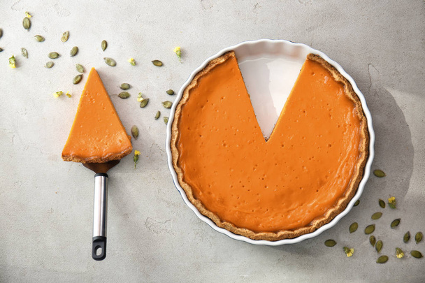 Flat lay composition with tasty pumpkin pie on table - Photo, image