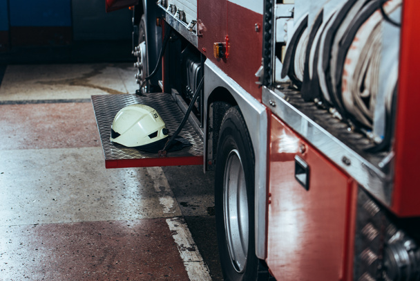 close up view of protective helmet on fire truck at fire station - Photo, Image