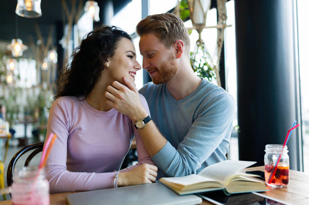Young happy couple on date in coffee shop having romantic times - Φωτογραφία, εικόνα