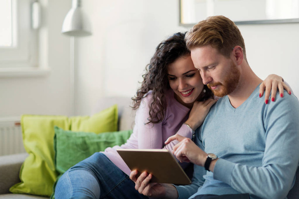 Young happy couple using digital tablet at home - Valokuva, kuva