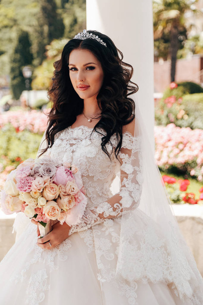 fashion outdoor photo of beautiful bride with dark hair in luxurious wedding dress  - Foto, immagini