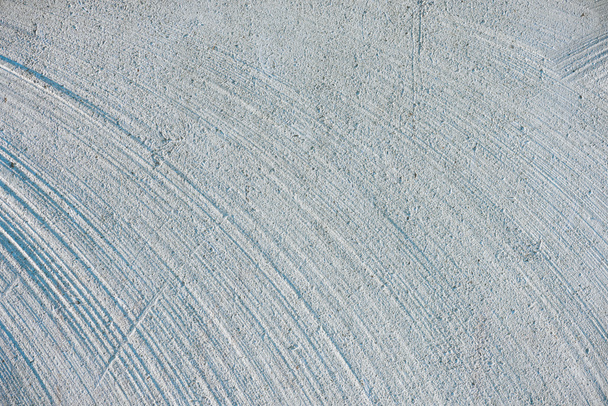 close up of white concrete wall with lines and curves - Фото, изображение