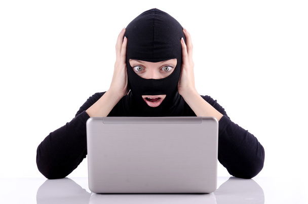 Hacker with computer wearing balaclava - Photo, image