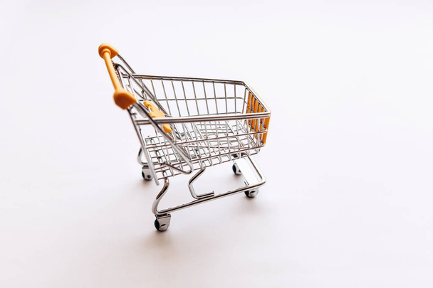 Empty cart for products and goods on a white background - Fotoğraf, Görsel
