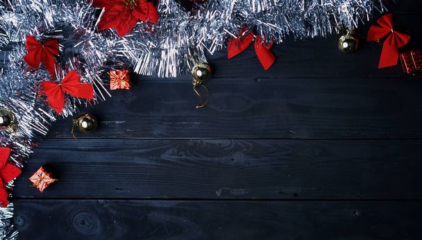 Copy Space. Silver Christmas Ornament on Black Wood Plank. Top View - Фото, зображення