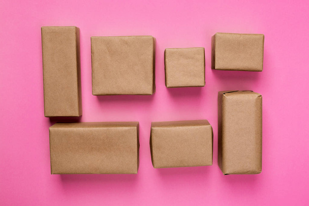 a lot of cardboard box on pink wooden background. top view. - Φωτογραφία, εικόνα