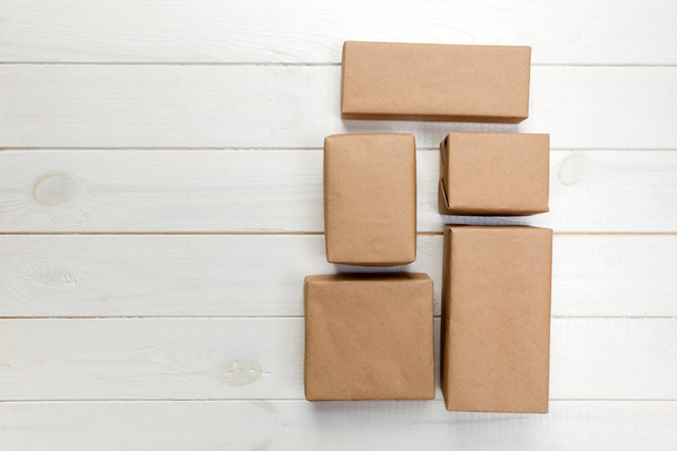 cardboard box on white wooden background, Brown mail package top view. - Φωτογραφία, εικόνα