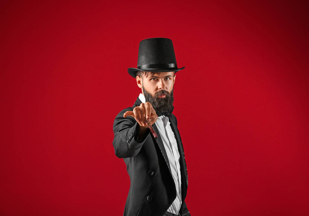 Male magician on color background - Photo, Image