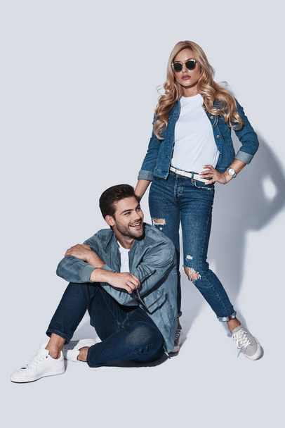 fashionable man and woman in denim wear posing in studio  - Foto, Imagem