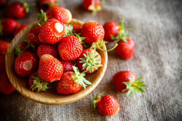 ripe red strawberry on a table with burlap - Valokuva, kuva