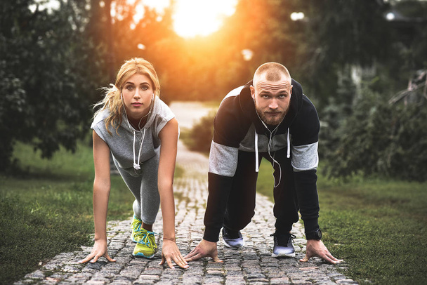 Urban sports - couple jogging for fitness in the city with beautiful nature. - Photo, Image