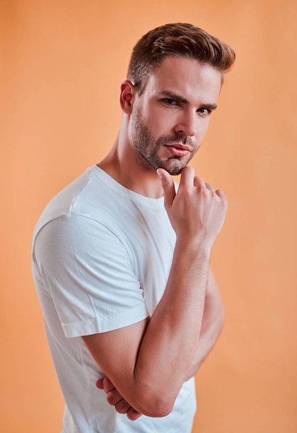 Handsome man isolated. Stylish young man posing on orange background. - Fotoğraf, Görsel