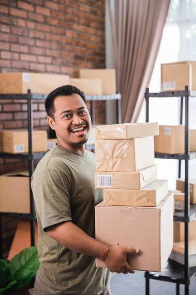 man courier holding package work at shipping package business - Фото, изображение