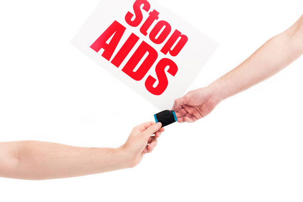 cropped image of girlfriend and boyfriend holding condom, card with stop aids text isolated on white - Photo, Image
