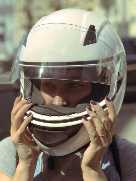 The girl in the helmet. Portrait of a girl in a helmet. Beautiful girl in a helmet - 写真・画像