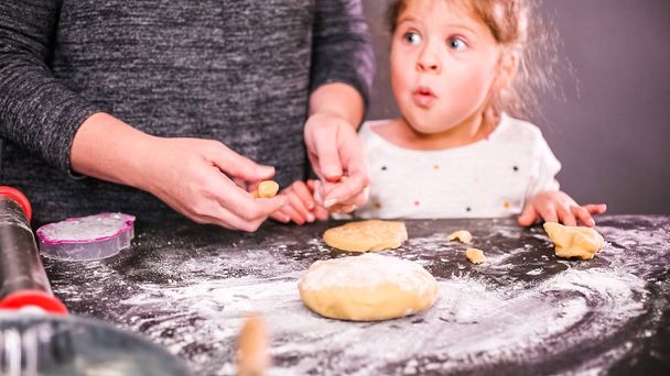 Mãe e filha assar biscoitos de crânio de açúcar para Dia de los Muertos feriado
. - Foto, Imagem