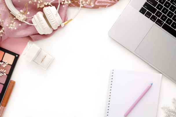 Fashion female pink accessories Set. Wedding ring in white gift box, laptop, headphones and notebook on white background. - Fotoğraf, Görsel