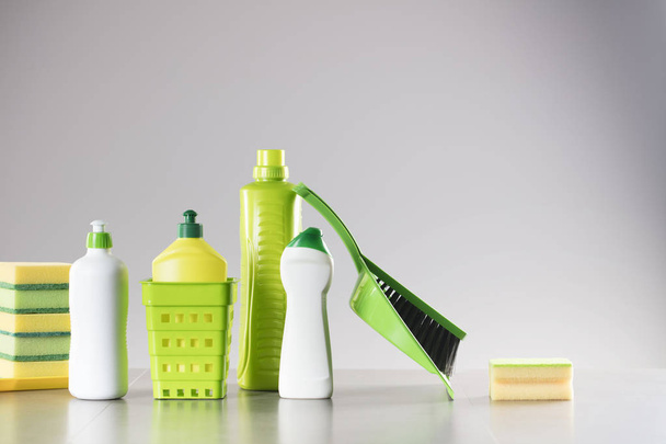 House and office cleaning up theme.  Set of colorful cleaning products on gray background. - Photo, Image