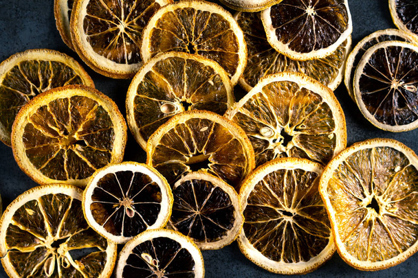 Sliced dried lemon and orange on dark background. Top view. - Foto, Imagem