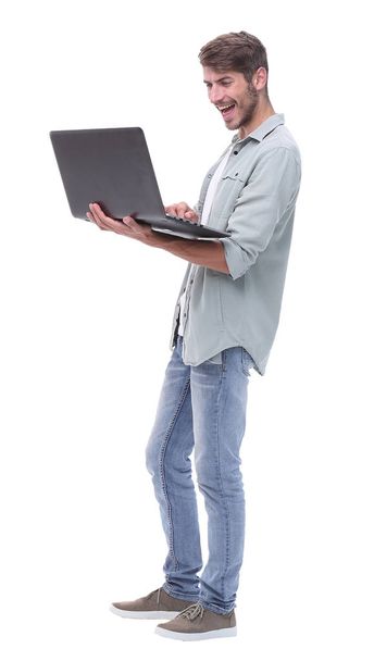 in full growth.smiling young man with laptop - 写真・画像