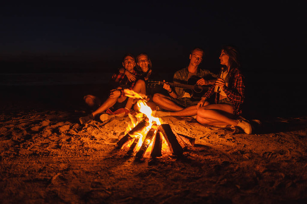 jovens amigos fazem piquenique com fogueira na praia
 - Foto, Imagem