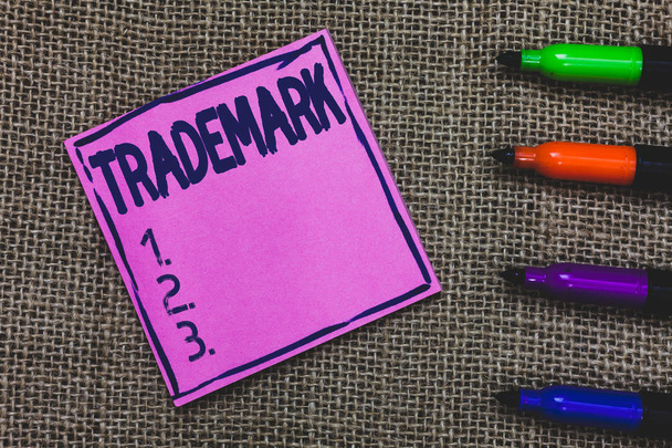 Conceptual hand writing showing Trademark. Business photo showcasing Legally registered Copyright Intellectual Property Protection Purple Paper Important reminder Markers Jute background. - Photo, Image