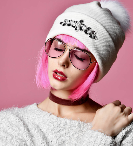 Модне мистецтво фото молодої жінки гранжевого стилю з рожевим волоссям в прозорих сучасних сонцезахисних окулярах і білому капелюсі
  - Фото, зображення