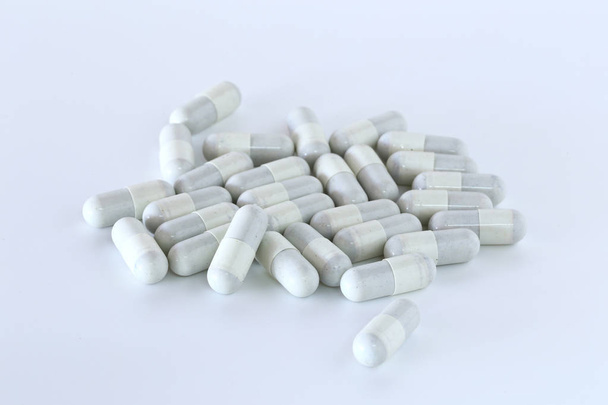 Many tablets, pills piled on a white background. - Photo, Image