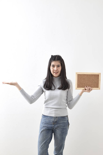 Closeup asian woman with cork board in hand with have an idea on white background - Foto, Imagen