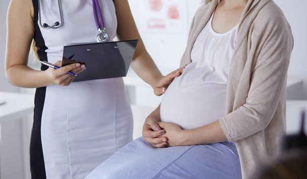Gynecology consultation. Pregnant woman with her doctor in clinic - Photo, Image