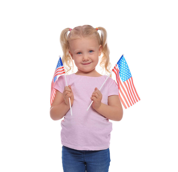 Portrait of cute little girl with American flags on white background - Φωτογραφία, εικόνα