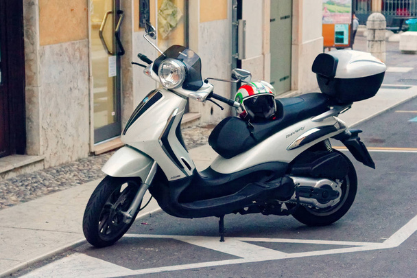 Soave, Italy-August 4, 2018: Soave Castle, a motorcycle on a city street - Fotografie, Obrázek