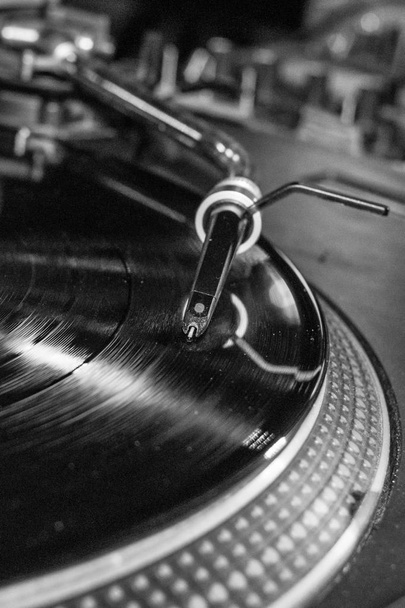 DJ console. Vinyl record. Retro party. Music from vinyl in a disco. The needle of the gramophone. Mixing console. House, funk, techno music. Soundtrack. Musical accompaniment of the holiday. - Photo, Image