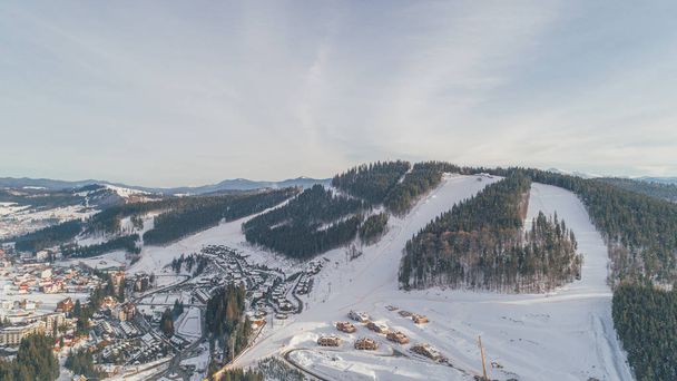 Aerial view of the mountains. Carpathians. Bukovel. Village. Winter. Snow. Forest. Trees - Foto, immagini