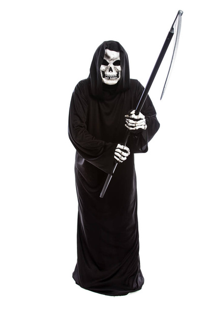 Costume of a skeleton grim reaper wielding a scary scythe.  The undead ghost is wearing a black robe to represent October Halloween holiday.  Isolated on a white background - Photo, Image