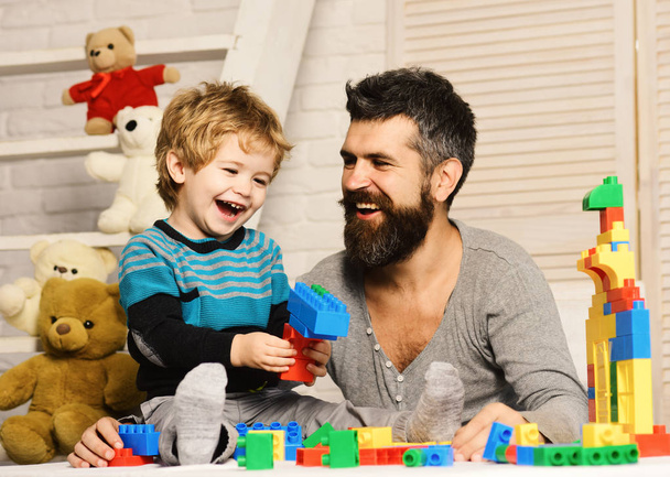 Boy and man play together. Dad and kid with toys - Foto, Imagem