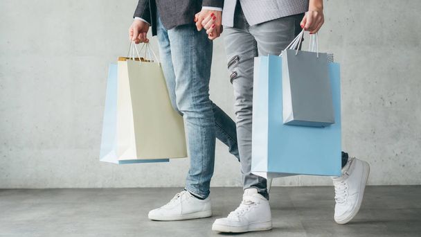 shopping therapy couple walking holding bags - Fotó, kép
