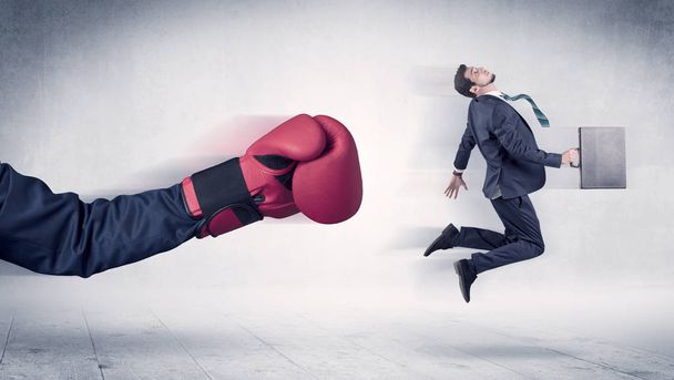 Huge Boxing Gloves punches businessman concept - Zdjęcie, obraz
