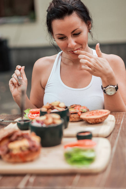 Cute woman eating tasty food. - Foto, Imagen