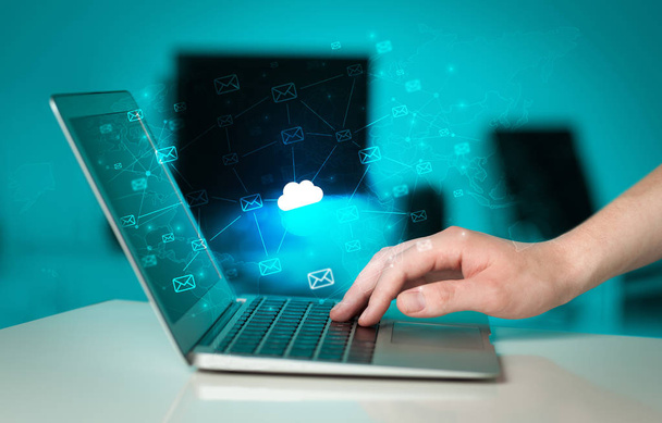 Hand using laptop with centralized cloud computing system concept - Photo, Image