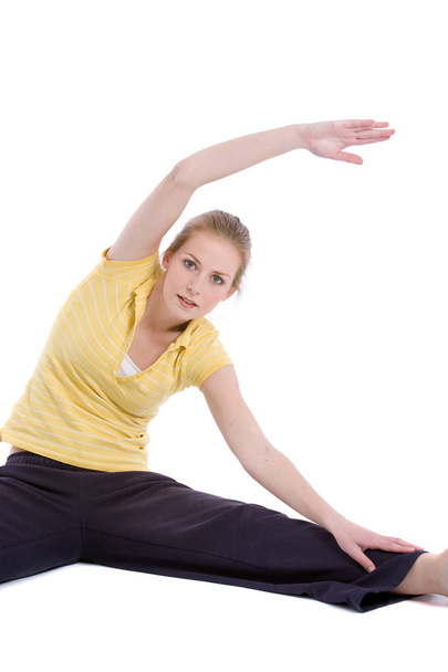 Pretty blond woman doing stretch exercises - Foto, Bild